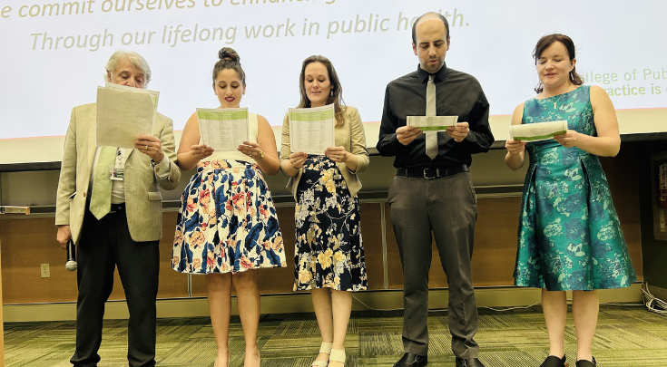 a group of people reading a paper