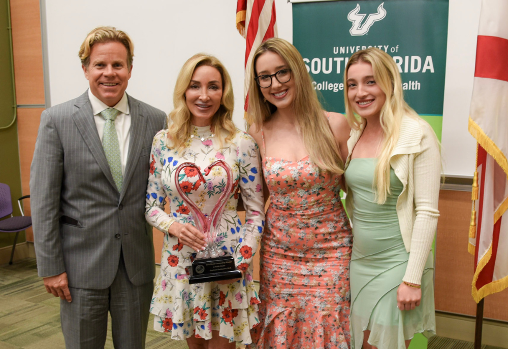 a blonde family of 4 with a dad, mom and two daughters