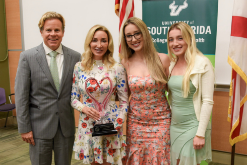 a blonde family of 4 with a dad, mom and two daughters