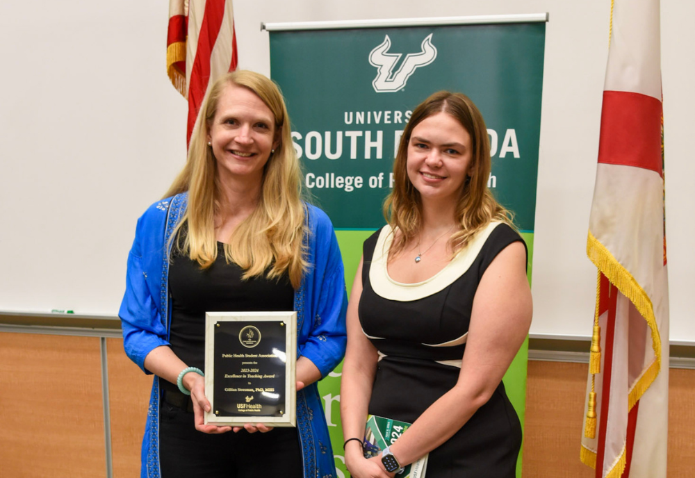 two women being presented with an award