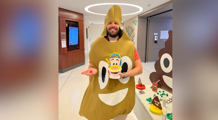 a person wearing a poop emoji costume 