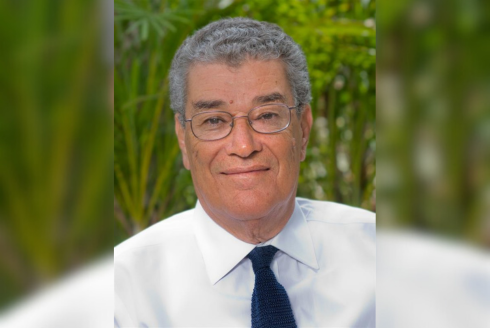 Dr. Yehia Y. Hammad, a man with grey hair and small wire-framed glasses, smiling outdoors.