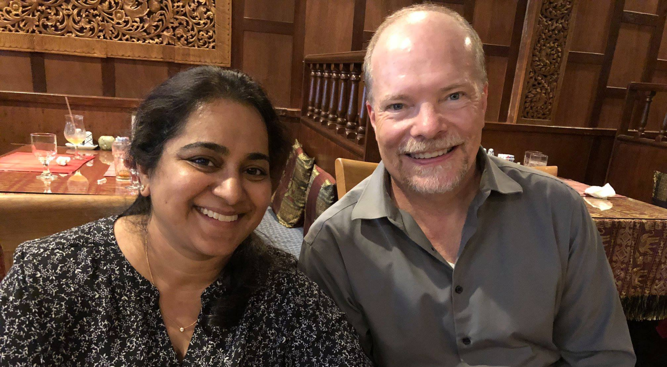 David smiling with another person at dinner.