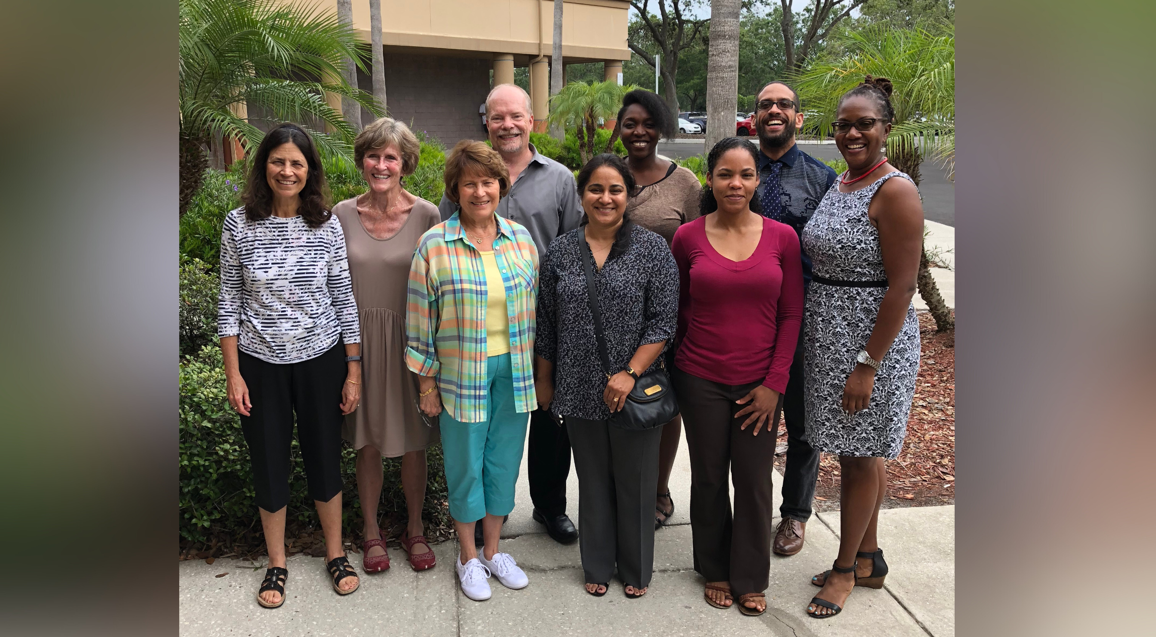 Dave Hogeboom standing in a group of people, all smiling.
