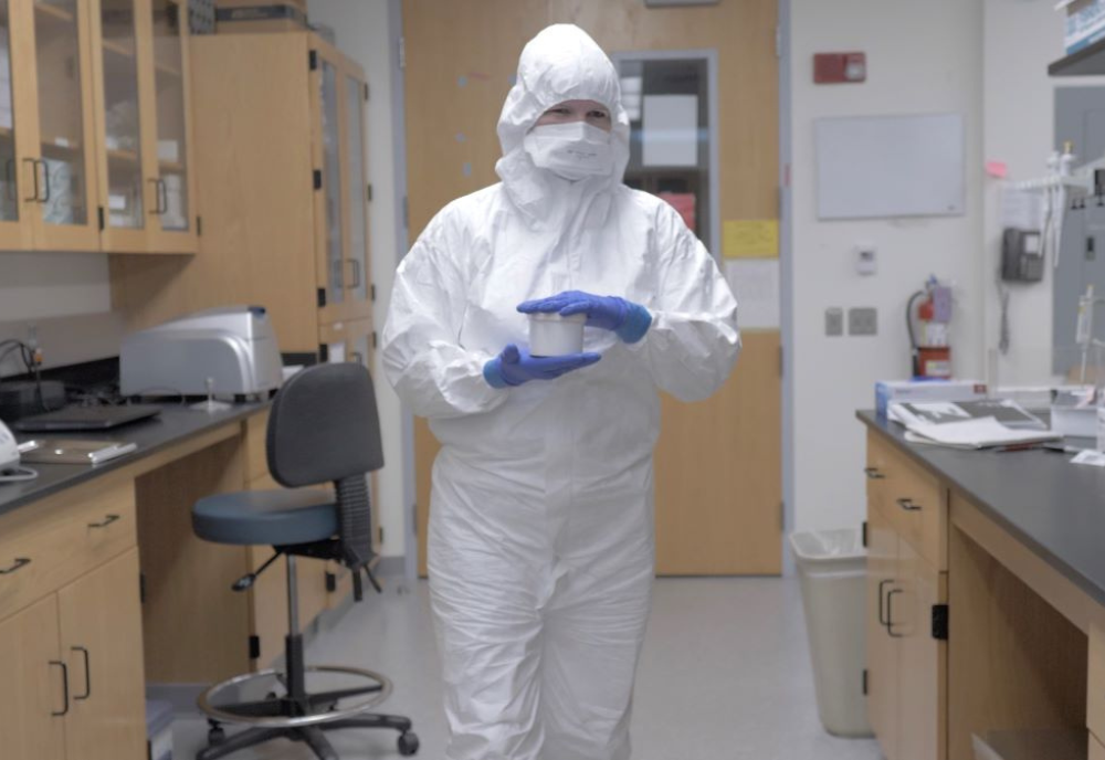 a woman in a hazmat suit