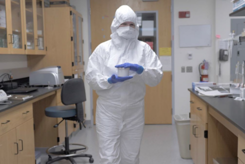 a woman in a hazmat suit