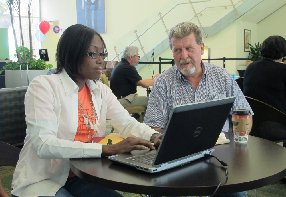two people looking at computer