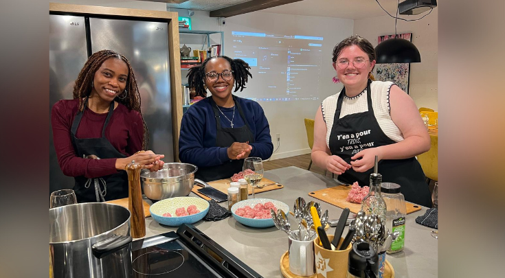 3 people in a kitchen making meatballs