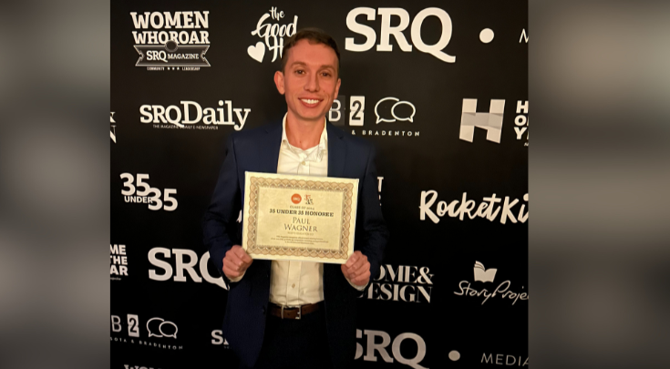 a person holding an award