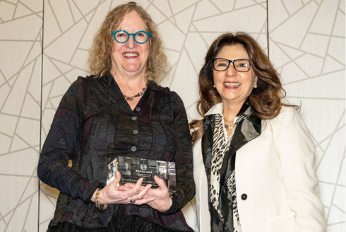 two women holding an award
