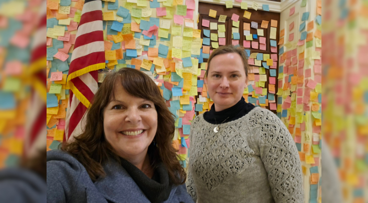 Doctors in a room full of post-it notes.
