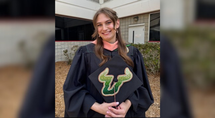 Danielle DeNofrio smiling in her cap and gown.