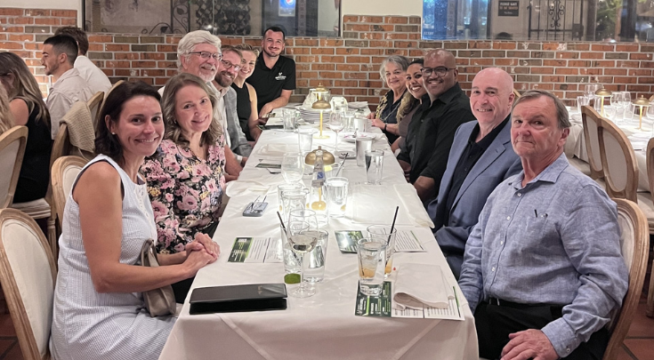 people smiling at a dinner table