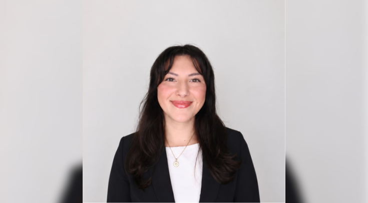 Gloria Arce smiling in a blazer.