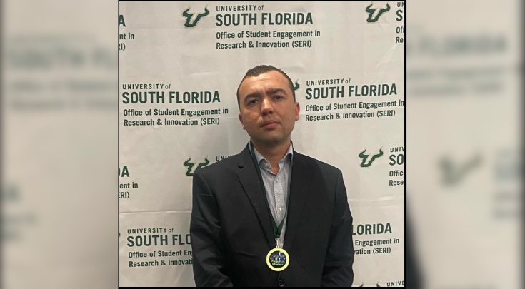 Ivan Diez-Muro receiving an award at USF.