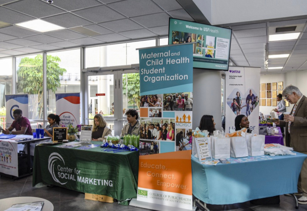 Various tables set up for the MSCHO symposium at the College of Public Health