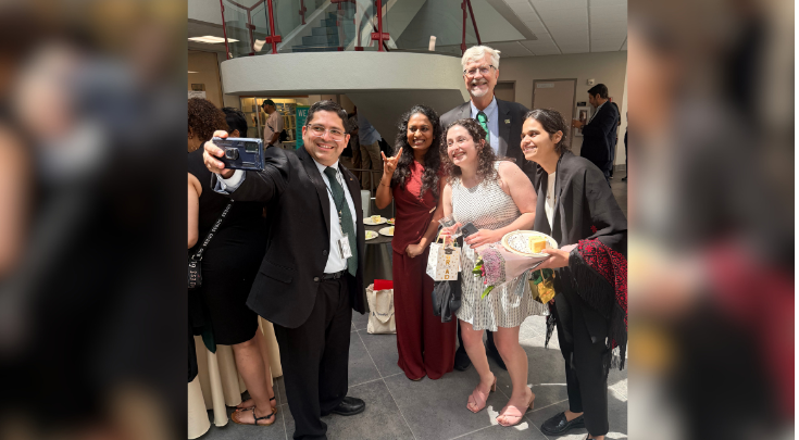 graduates at a reception smiling for a picture