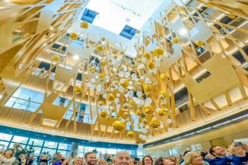 Gold and white balloons fall at the Judy Genshaft Honors College building Grand Opening.