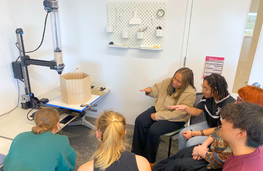 Honors students gather around a 3D printed oyster brick.