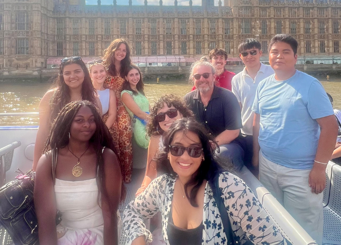 A group of students posing alongside Dr. Benjamin Young on the boat cruise at the end of the trip.