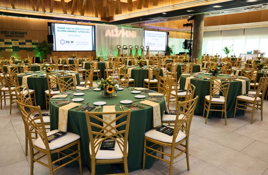 atrium full of round tables and chairs and a stage