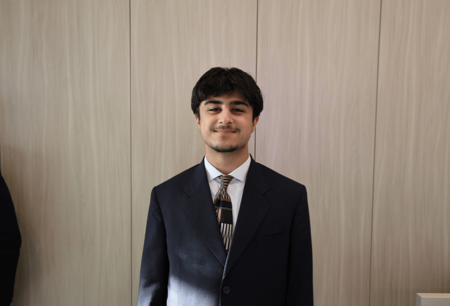 Headshot of Bilal Agha standing in front of a blank background