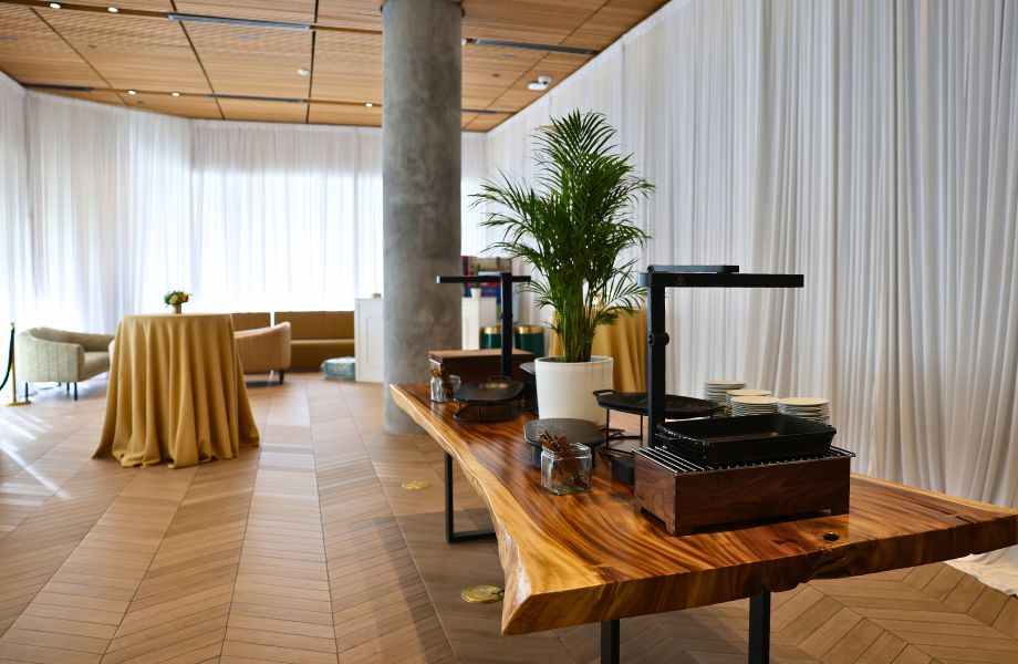 cafe with long table and floor-to-ceiling curtains covering the windows