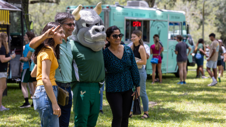 Family standing with Rocky the Bull 