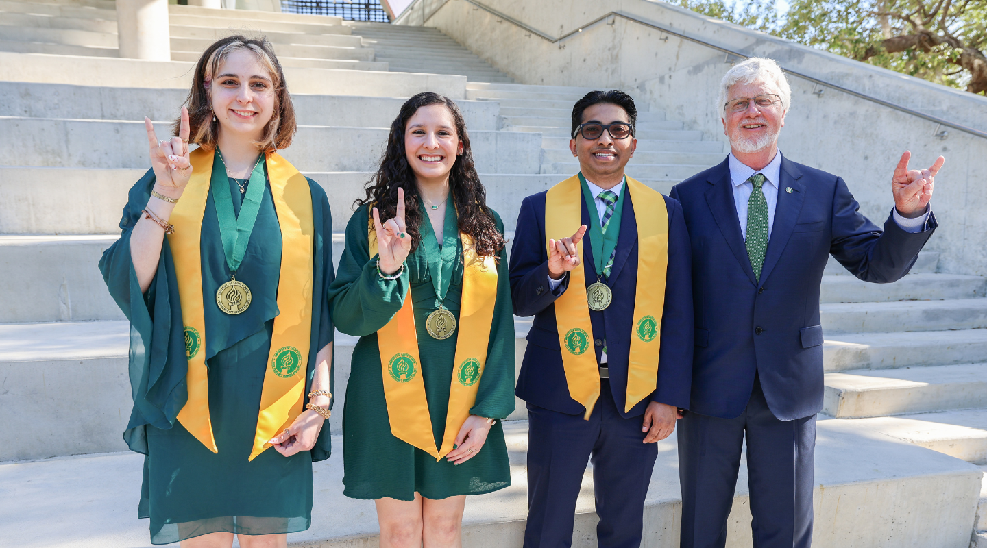 Spring 2026 Dean's Circle of Merit Winners with Dean Adams, Judy Genshaft, and Steve Greenbaum outside the Honors amphitheater.