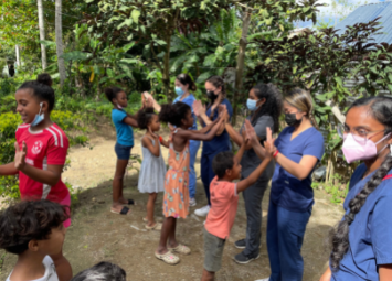 Students stand with Dr. Kerolle from the Kerolle Initiative located in the Dominican Republic