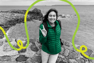 Honors student Reva Ghandi smiles in front of the ocean on the English coast.