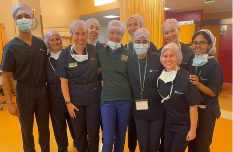 Florence physician observations students wear medical equipment while shadowing doctors in a clinic.
