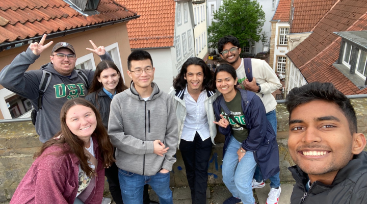Students on the trip smile for a group photo