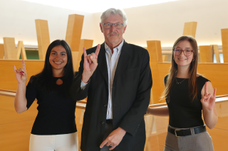 Alison Frate, Dr. Gregory Smogard, and Abigail Brake show their bull pride on the fifth floor of the Honors building, overlooking the atrium.