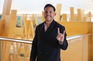 Honors alum Hiram Rios Hernandez poses in the Judy Genshaft Honors College building.