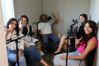 Honors affiliate faculty member Deepak Singh recording in a podcast studio wtih Honors students Fabiana Requena, Caroline Merriman, Amelie McLeod, and Daniella Charco