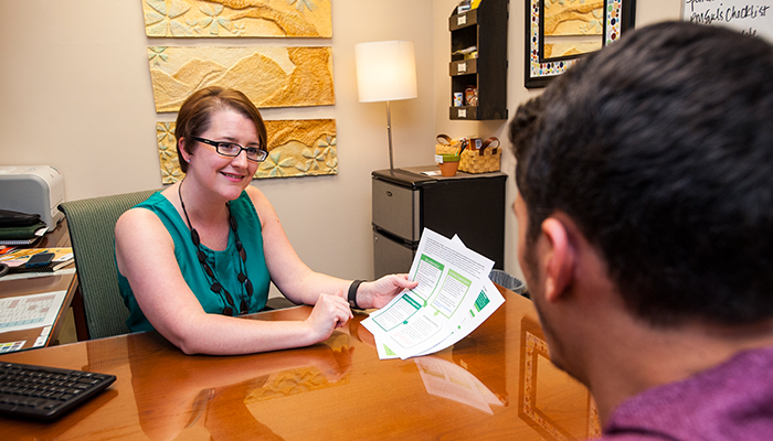 Honors staff advising a student on available resources