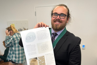 Ian Blair-Catala holding an ORB poster