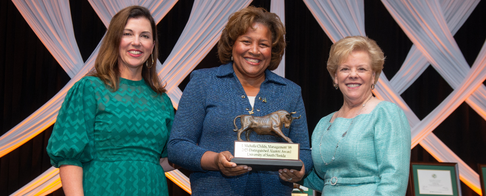 Judge childs accepts distinguished alumni award.