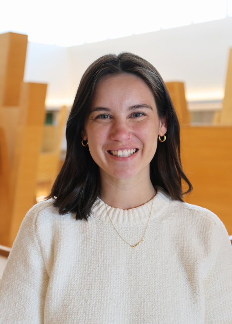 Kirsten Park Lisenbery headshot on 5th floor of Honors building overlookinga atrium