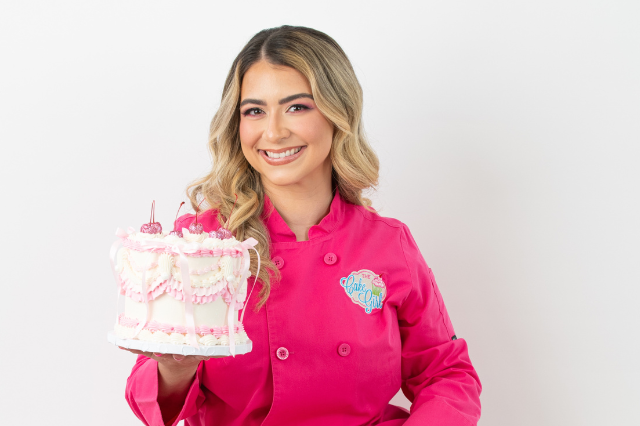 Kristina Lavallee of The Cake Girl holds up cake