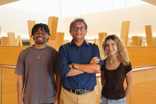Daniel Anderson, Deepak Singh, and Jenna Epright pose on the fifth floor of the Honors building.