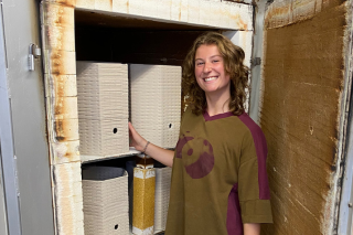 Lily Boyer stands next to Oyster Brick models