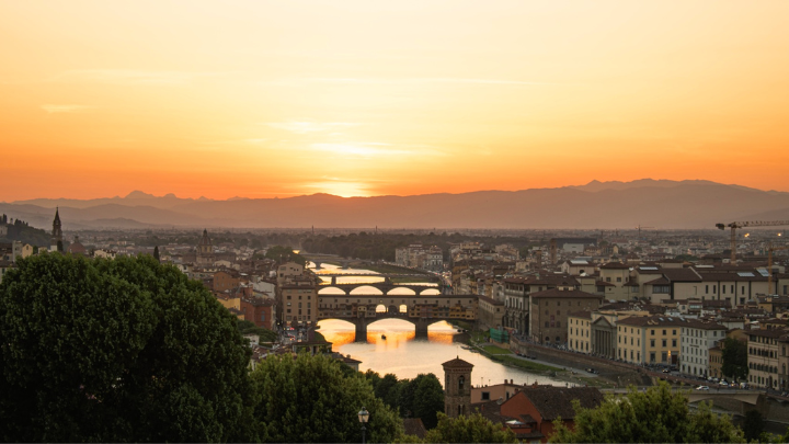 Sunset over Florence Italy. Orange skies above the Arno river.