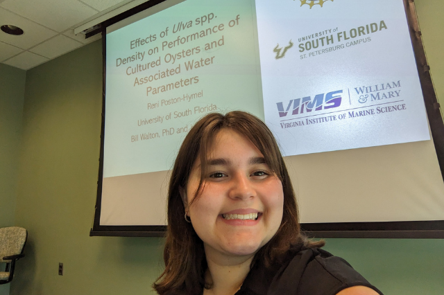Reni posing with her research presentation.