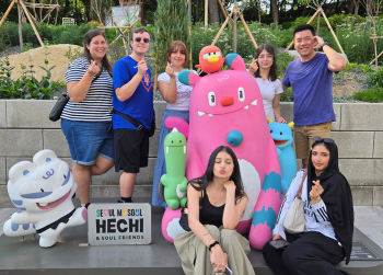 South Korea Beyond the Classroom photo with Honors students and staff posing with cartoon statues