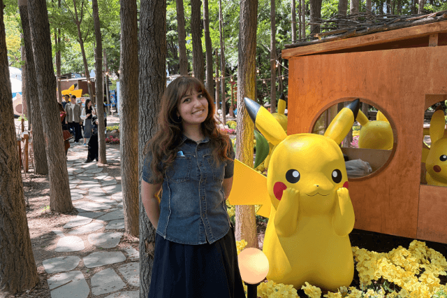 Silvana Guevara posing next to a Pikachu Pokemon statue