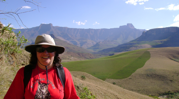 Student smiles overlooking mountains