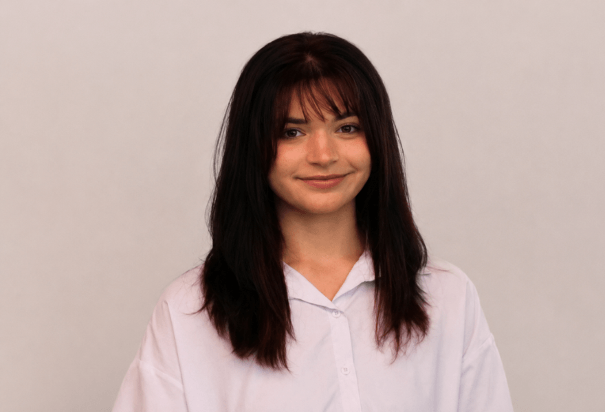 Headshot of Stella Azam standing in front of a blank background