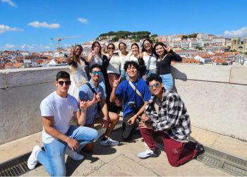 Image of small group of students posing on a roof overlooking the city linking to Portugal Beyond the Classroom study abroad program webpage.